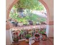 Covered front porch decorated with potted plants and hanging baskets, offering a cozy and inviting outdoor space at 4834 E Van Buren Ave, Las Vegas, NV 89110