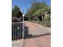 Charming home with gated entry, a spacious yard, and mature trees at 4834 E Van Buren Ave, Las Vegas, NV 89110