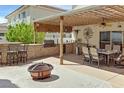 Outdoor kitchen and dining area featuring a built-in grill, counter space, and ample seating at 603 Fiddlehead Ave, Las Vegas, NV 89183