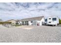 Spacious backyard with gravel landscaping, RV parking, and storage shed at 681 Indian Wells Ct, Pahrump, NV 89060