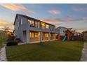 Spacious backyard with artificial turf, covered patio, and a playset at 7364 Marbury St, Las Vegas, NV 89166