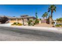 Beautiful single-story home with desert landscaping, palm trees, and a three-car garage at 768 Flowing Meadow Dr, Henderson, NV 89014