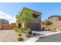 Two-story home with desert landscaping, a two-car garage, and a mix of stone and stucco finishes at 9641 Rankin Ridge Ct, Las Vegas, NV 89178