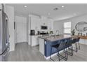 Beautiful kitchen featuring an island with bar stool seating, stainless steel appliances, and neutral countertops at 9641 Rankin Ridge Ct, Las Vegas, NV 89178