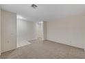 Spacious carpeted living room with bright neutral walls, ready for your personal touch and customization at 1012 Vanier Ct, Henderson, NV 89052