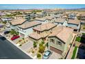 An aerial view showcases the property with a two-car garage and desert landscaping in a quiet neighborhood at 10352 Rye Patch Creek St, Las Vegas, NV 89141