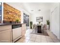 Eat-in kitchen with wood accent wall, stainless appliances, and sliding door to the backyard at 110 Wynntry Dr, Henderson, NV 89074
