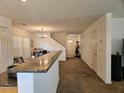View of living room showcasing bar and access to the front entry at 1169 Paradise River Rd, Henderson, NV 89002