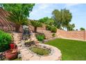 Backyard oasis features a serene rock waterfall, creating a peaceful and inviting outdoor space at 11764 Golden Moments Ave, Las Vegas, NV 89138