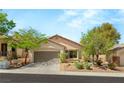 Charming single-story home with a well-manicured front yard and a two-car garage at 11764 Golden Moments Ave, Las Vegas, NV 89138