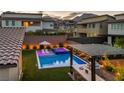 Backyard oasis with pool, hot tub, covered patio, BBQ, and mountain views at 11954 Camden Ridge Ct, Las Vegas, NV 89138
