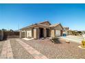 Attractive single-story home featuring desert landscaping and a decorative brick walkway at 1301 Nugget Creek Dr, Las Vegas, NV 89108