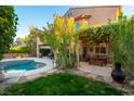 Charming backyard with a pool, patio dining area, and lush greenery for relaxing outdoors at 2434 Amoretti St, Henderson, NV 89052