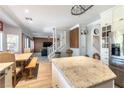 Open concept kitchen leading to dining and living areas, wood floors, and lots of light at 2434 Amoretti St, Henderson, NV 89052