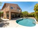 Enjoy the backyard oasis with a refreshing pool, covered patio, and a charming balcony overlooking the serene space at 2434 Amoretti St, Henderson, NV 89052
