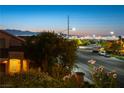 An elevated street view displays the city skyline against a colorful dusk backdrop at 2434 Amoretti St, Henderson, NV 89052