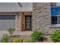 Close-up of front door with stone accents and desert landscaping at 2579 Speyburn Ave, Henderson, NV 89044