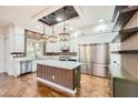 Modern kitchen featuring a large island, stainless steel appliances, and custom wood accents at 3198 Stella Cilento Ave, Henderson, NV 89044