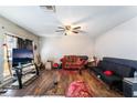 Spacious living room featuring wood floors, a ceiling fan, and ample natural light at 343 Tungsten St, Henderson, NV 89015