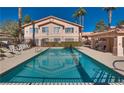 Beautiful pool reflecting the community buildings under a clear sky, offering a refreshing oasis for residents at 350 S Durango Dr # 220, Las Vegas, NV 89145