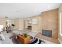 Bright living room with brick fireplace and dining area at 3558 Wayne Cir, Las Vegas, NV 89121