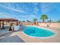 Inviting backyard with a sparkling private swimming pool, mature palms, and patio area at 3558 Wayne Cir, Las Vegas, NV 89121