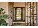 Close-up of a front door with decorative glass and iron security gate in front of a house at 3753 S Rosecrest Cir, Las Vegas, NV 89121