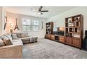 Spacious living room featuring plush carpet, media center, and comfortable seating at 489 Filaree Pl, Henderson, NV 89015