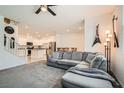 Inviting living room with comfortable seating, modern decor, and an open floor plan to the kitchen at 489 Filaree Pl, Henderson, NV 89015
