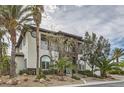 Stunning two-story home with stone accents, balcony, manicured landscaping, and a circular window at 5367 Secluded Brook Ct, Las Vegas, NV 89149