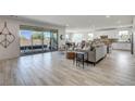 Open-concept living area with tile floors, slider patio doors, and a view of the backyard at 6830 Compass St, North Las Vegas, NV 89084