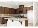 Modern kitchen with granite countertops, stainless steel appliances, and ample cabinet space at 7189 Ashcroft St, North Las Vegas, NV 89084