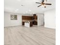 Spacious living room featuring recessed lighting, ceiling fan, and wood-look flooring at 7189 Ashcroft St, North Las Vegas, NV 89084