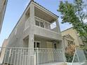 Two-story home features a cozy balcony and well-maintained landscaping at 7412 Bewitching Ct, Las Vegas, NV 89149