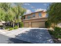 Charming two-story home with landscaped yard, mature tree and a spacious two-car garage and large driveway at 7736 Villa Andrade Ave, Las Vegas, NV 89131