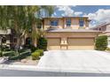 Charming home with a three-car garage, mature trees, and manicured shrubs at 7736 Villa Andrade Ave, Las Vegas, NV 89131