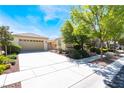 Welcoming single-story home boasting a two-car garage, neutral exterior, and green landscaping at 8236 Imperial Lakes St, Las Vegas, NV 89131