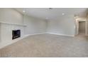 Open living room featuring neutral carpet, recessed lighting, and a cozy white fireplace at 8804 River Pines Ct # 202, Las Vegas, NV 89117