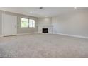 Spacious carpeted living room with natural light, featuring a fireplace and recessed lighting at 8804 River Pines Ct # 202, Las Vegas, NV 89117