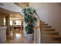 Elegant curved staircase featuring carpeted steps and wood railing, illuminated by natural light in a spacious home interior at 9905 Fox Springs Dr, Las Vegas, NV 89117