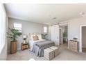 Relaxing bedroom with neutral tones, a barn door leading to the bathroom, and ample natural light at 16 Cresta Villa Ct, Henderson, NV 89011