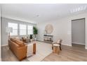 Inviting living room with wood floors, a comfortable sofa, and large windows for natural light at 16 Cresta Villa Ct, Henderson, NV 89011