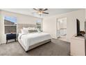Spacious main bedroom with plush carpet, ceiling fan, and ensuite bathroom access at 1783 Matteo Cove Pl, North Las Vegas, NV 89084