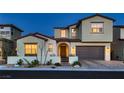 Inviting two-story home with warm exterior lighting and meticulously maintained landscaping at 182 Robledo St, Las Vegas, NV 89138