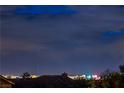 Distant city skyline is visible from the roofline of this home at 2248 Verde Cape Ave, Henderson, NV 89052