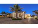 Stunning exterior view of a single story home showcasing desert landscaping, a circular driveway, and an elegant facade at 2780 El Camino Rd, Las Vegas, NV 89146