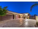 Spacious three-car garage with decorative driveway featuring gated access and desert landscaping at 2780 El Camino Rd, Las Vegas, NV 89146