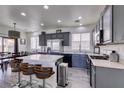 Modern kitchen featuring gray cabinets, stainless steel appliances, and a center island with bar seating at 2929 Salado Creek Ave, North Las Vegas, NV 89081