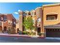 Beautiful townhome with a turret architectural design and mature landscaping at 3975 N Hualapai Way # 212, Las Vegas, NV 89129