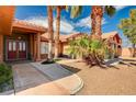 Home featuring a stone front accent wall, covered porch and double-door front entrance at 4775 N Grand Canyon Dr, Las Vegas, NV 89129